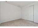 Clean, empty bedroom with a carpeted floor, white walls, and a double door closet at 9062 Telluride Ct, Commerce City, CO 80022