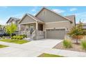 Well-maintained two-story home with a tidy front yard and attached two-car garage on a sunny day at 24314 E Ford Ave, Aurora, CO 80018