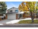 Two-story brick home with a large tree in front at 4122 S Andes Way, Aurora, CO 80013