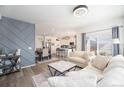 Open-concept living area with a dining area, hardwood floors, and views into the kitchen at 10207 Xanadu St, Commerce City, CO 80022