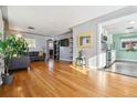 Open living room with hardwood floors and kitchen view at 2594 S Tennyson Way, Denver, CO 80219