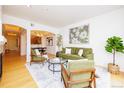 Open living area with a green sofa, modern furniture, art, and lots of natural light at 1747 N Washington St # C303, Denver, CO 80203