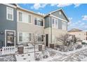 Charming two-story townhouse with a picket fence and well-maintained front yard at 15550 W 64Th Pl # D, Arvada, CO 80007