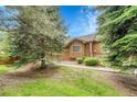 View of the house with wooden sidings, shrubs and lawn at 11820 W 66Th Pl # C, Arvada, CO 80004