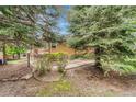 Inviting exterior view with mature trees, walkway, and well-maintained landscaping at 11820 W 66Th Pl # C, Arvada, CO 80004