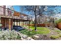 Spacious backyard with a deck and lush green lawn, perfect for outdoor entertaining at 10346 E Crestridge Ln, Englewood, CO 80111