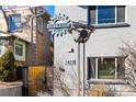 Building entrance with a unique metal gate and sign at 1419 Detroit St # 25, Denver, CO 80206