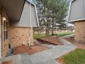 Exterior view of landscaped common area, bench and pathway between the townhomes at 1517 S Owens St # 9, Denver, CO 80232