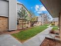 Exterior view of landscaped common area and pathway between the townhomes at 1517 S Owens St # 9, Denver, CO 80232
