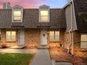 Charming brick townhome with a landscaped yard and inviting entrance at 1517 S Owens St # 9, Denver, CO 80232