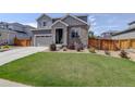 Charming two-story home with a well-maintained lawn and attached two-car garage at 6889 E 119Th Ave, Thornton, CO 80233
