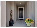 Inviting front porch with decorative water fountain and colorful potted flowers at 6889 E 119Th Ave, Thornton, CO 80233
