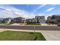 Neighborhood street featuring manicured lawns and sidewalks on a sunny day at 6889 E 119Th Ave, Thornton, CO 80233