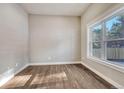 Well-lit room with wood floors, a large window, and neutral paint at 93 Greeley Blvd, Palmer Lake, CO 80133
