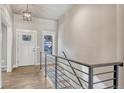 Bright entryway with wood flooring, staircase with modern railing, and natural light at 93 Greeley Blvd, Palmer Lake, CO 80133