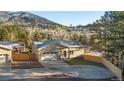 Attractive home with a well-manicured lawn, concrete driveway, a two-car garage, and scenic neighborhood views at 93 Greeley Blvd, Palmer Lake, CO 80133
