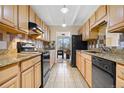 Galley kitchen with stainless steel appliances, granite countertops, and ample cabinet space at 7865 E Mississippi Ave # 105, Denver, CO 80247