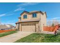 Two-story home with a two-car garage and a well-manicured lawn, set against a bright blue sky at 11020 Glacier Park Cir, Parker, CO 80138