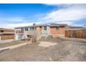 Home featuring a split-level design with a garage and inviting front porch seating area at 16805 W 16Th Pl, Golden, CO 80401