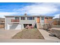 Charming home featuring a split-level design, garage, and quaint front porch seating area at 16805 W 16Th Pl, Golden, CO 80401