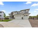 Desirable two-story home with a two-car garage, manicured lawn, and an extended driveway at 423 Rogers Way, Castle Rock, CO 80104