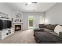Comfortable living room with a fireplace, balcony access, and neutral decor at 23346 E 5Th Pl # 101, Aurora, CO 80018