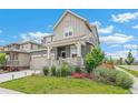Beautifully landscaped front yard with a charming porch, enhancing the curb appeal of this lovely two-story home at 2520 Canfield Ln, Erie, CO 80026