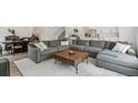 Spacious living room features a plush gray sectional sofa and neutral patterned rug at 2520 Canfield Ln, Erie, CO 80026