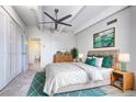 Bright bedroom featuring a ceiling fan and en-suite bathroom, accented with a plush rug and stylish decor at 130 N Pearl St # 1606, Denver, CO 80203