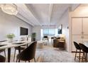 Open concept living room with a modern design, white walls, light floors, and a balcony offering beautiful views at 130 N Pearl St # 1606, Denver, CO 80203