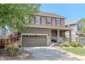 Attractive two-story home with a covered front porch, complemented by mature landscaping and a two-car garage at 7312 Grady Cir, Castle Rock, CO 80108