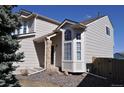 Stylish home exterior featuring a covered front entry, bay windows, and low-maintenance landscaping at 10510 Berthoud Way, Parker, CO 80134