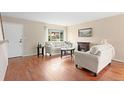 Cozy living room features hardwood floors, large windows, and neutral decor at 4212 W Pondview Dr, Littleton, CO 80123