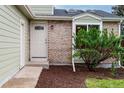 Front door entrance with brick detail and manicured landscaping at 2777 S Sedalia St, Aurora, CO 80013