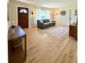 Cozy living room features hardwood floors, modern furnishings, and ample natural light from the window at 4425 E Harvard Ave, Denver, CO 80222