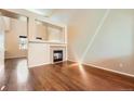 Bright living room featuring hardwood floors and a fireplace at 20229 E Red Fox Ln, Centennial, CO 80015