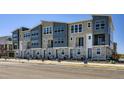 New townhome community showcasing modern exteriors with stone accents and gray siding in a contemporary design at 20578 E 63Rd Ave, Aurora, CO 80019