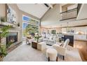 Open concept living room boasts a fireplace, vaulted ceilings, and lots of natural light at 7067 Gray Fox Ct, Highlands Ranch, CO 80130