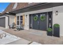 Inviting front entry with double doors and stylish planters at 5963 W Indore Pl, Littleton, CO 80128