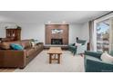 Inviting living room featuring a brick fireplace, plush seating and natural light at 13610 W Dakota Pl, Lakewood, CO 80228