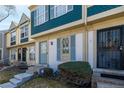 Charming townhome featuring a blue front door, updated windows, and well-maintained landscaping at 1621 S Idalia Cir # D, Aurora, CO 80017