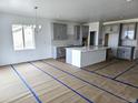 Spacious kitchen featuring gray cabinets, a center island, and modern finishes, ready for customization and move-in at 17105 W 92Nd Loop, Arvada, CO 80007