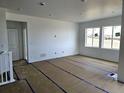 Bright living room featuring large windows offering plentiful natural light and a view of the neighborhood at 17105 W 92Nd Loop, Arvada, CO 80007