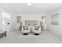 Spacious main bedroom showcasing a sitting area, plush carpeting and neutral tones at 6128 Songbird Cir, Boulder, CO 80303