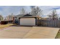 Wide driveway leading to a two-car garage with a basketball hoop visible on the side at 5398 S Truckee Ct, Centennial, CO 80015