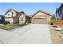 Lovely home features an attached garage with a wide driveway and low maintenance yard at 12201 Village Cir, Brighton, CO 80603