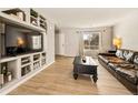 Living room showcasing built-in shelving and hardwood floors at 21621 Stoll Pl, Denver, CO 80249