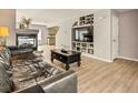 Living room with built-in shelving and hardwood floors at 21621 Stoll Pl, Denver, CO 80249