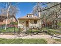 Attractive home featuring a fenced front yard and a covered front porch at 2314 Dexter St, Denver, CO 80207