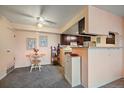 Cozy dining area with a ceiling fan, decor art and an opening into the kitchen at 13393 E Asbury Dr # 103, Aurora, CO 80014
